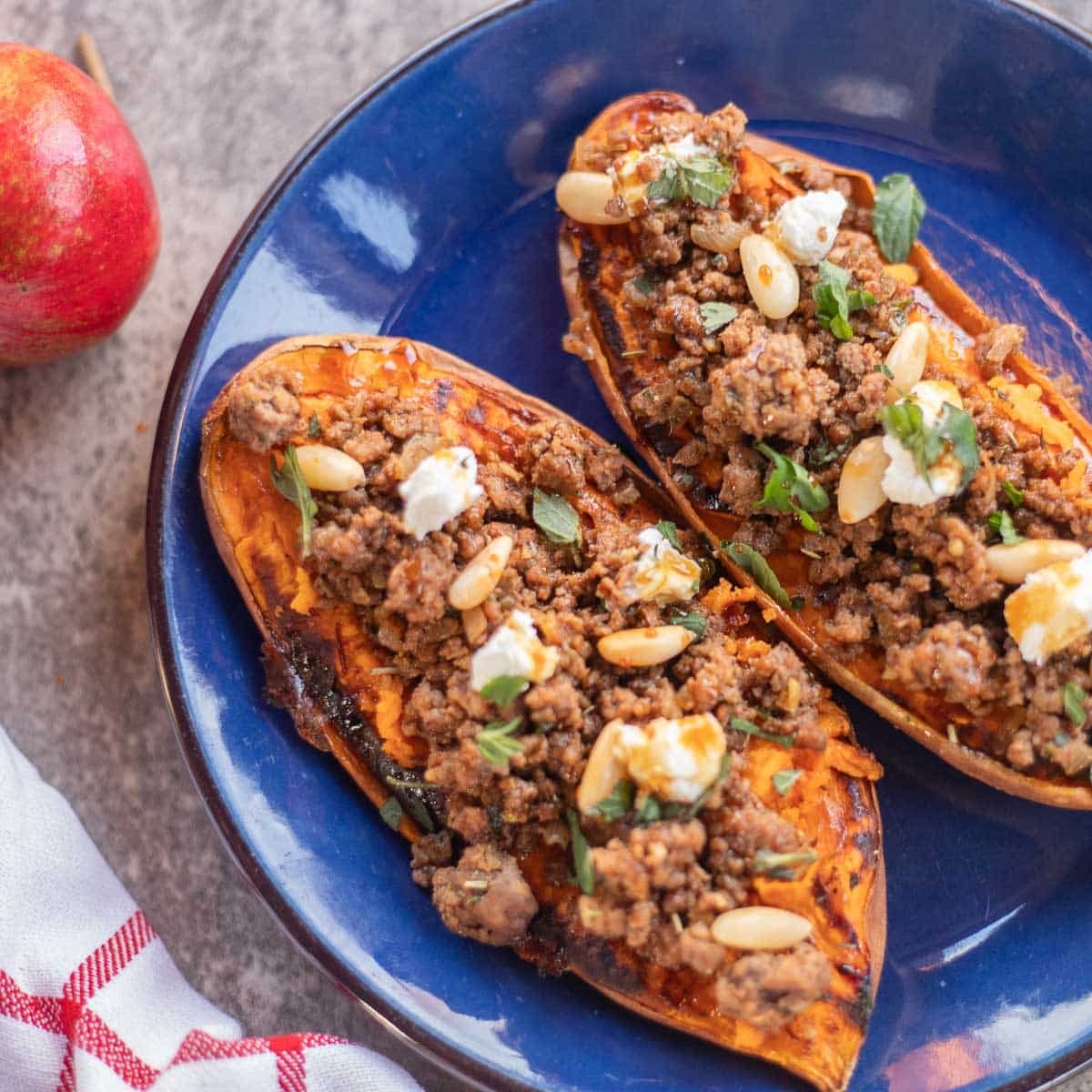 stuffed sweet potato boats on a blue plate.