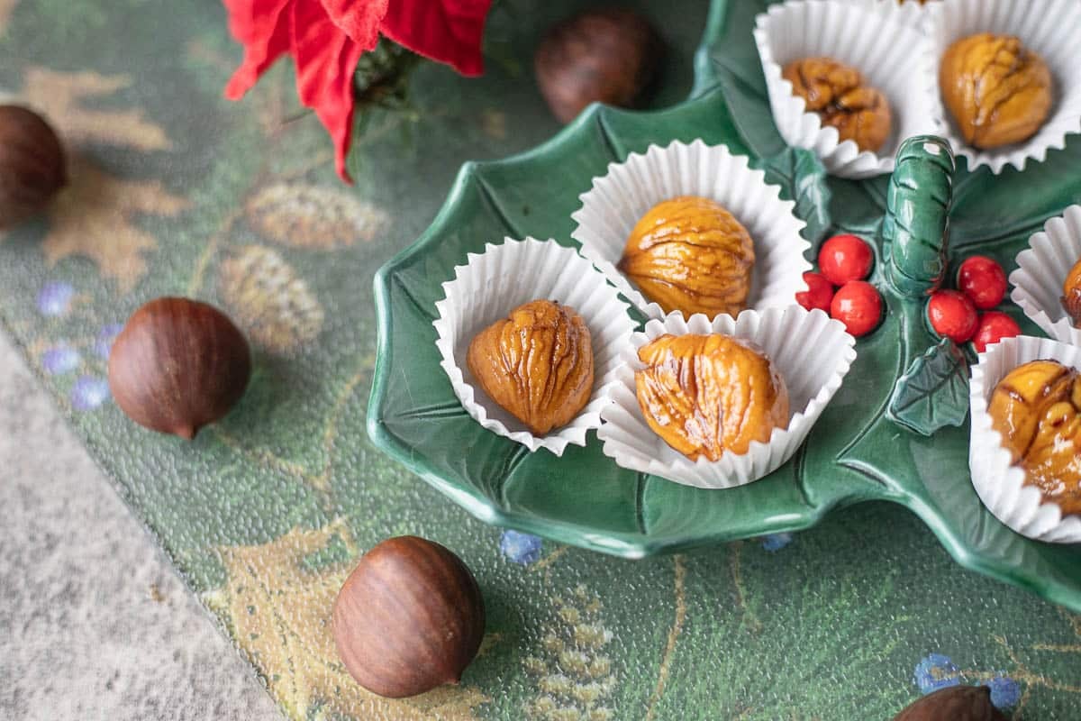 marron glace candied chestnuts on a green plate. 