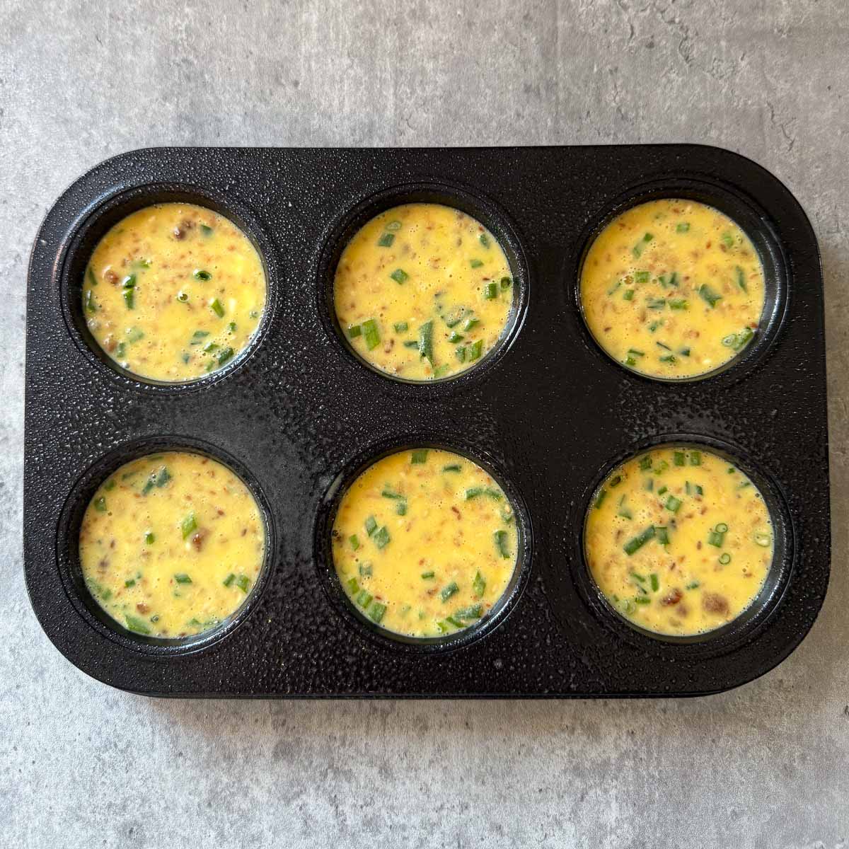eggs in muffin tin before baking