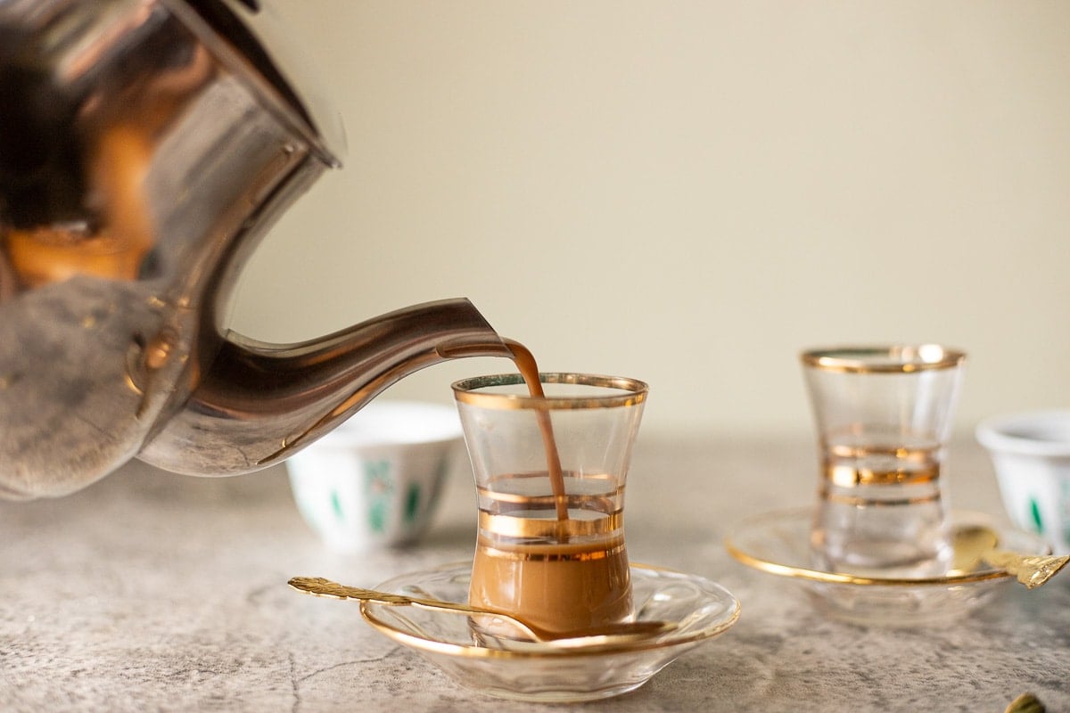pouring karak tea in glass cups