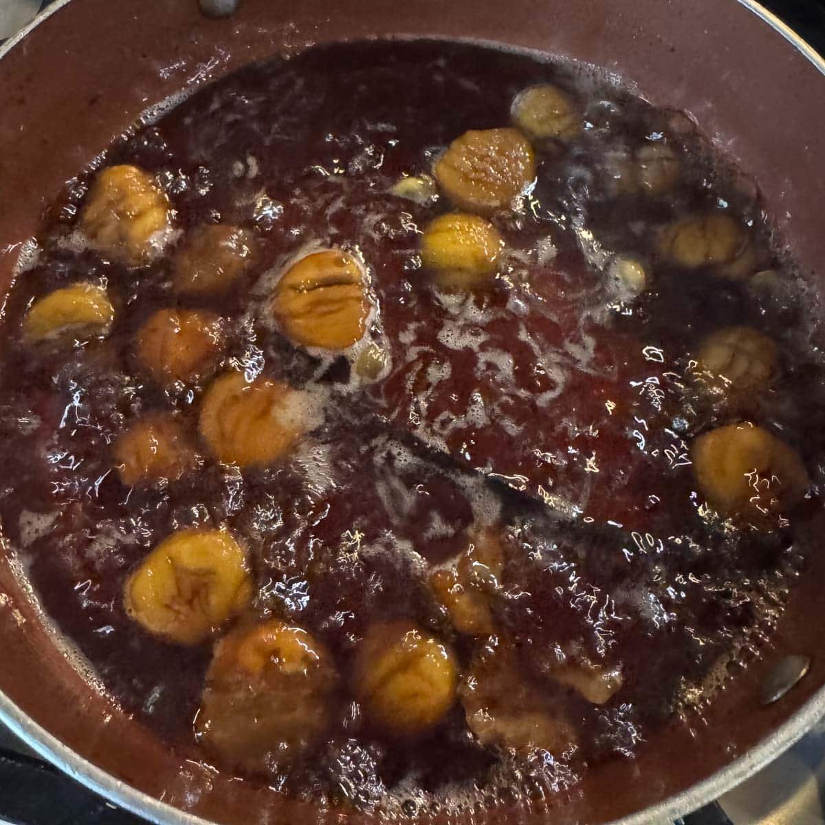 marron glace being prepared in a pan.