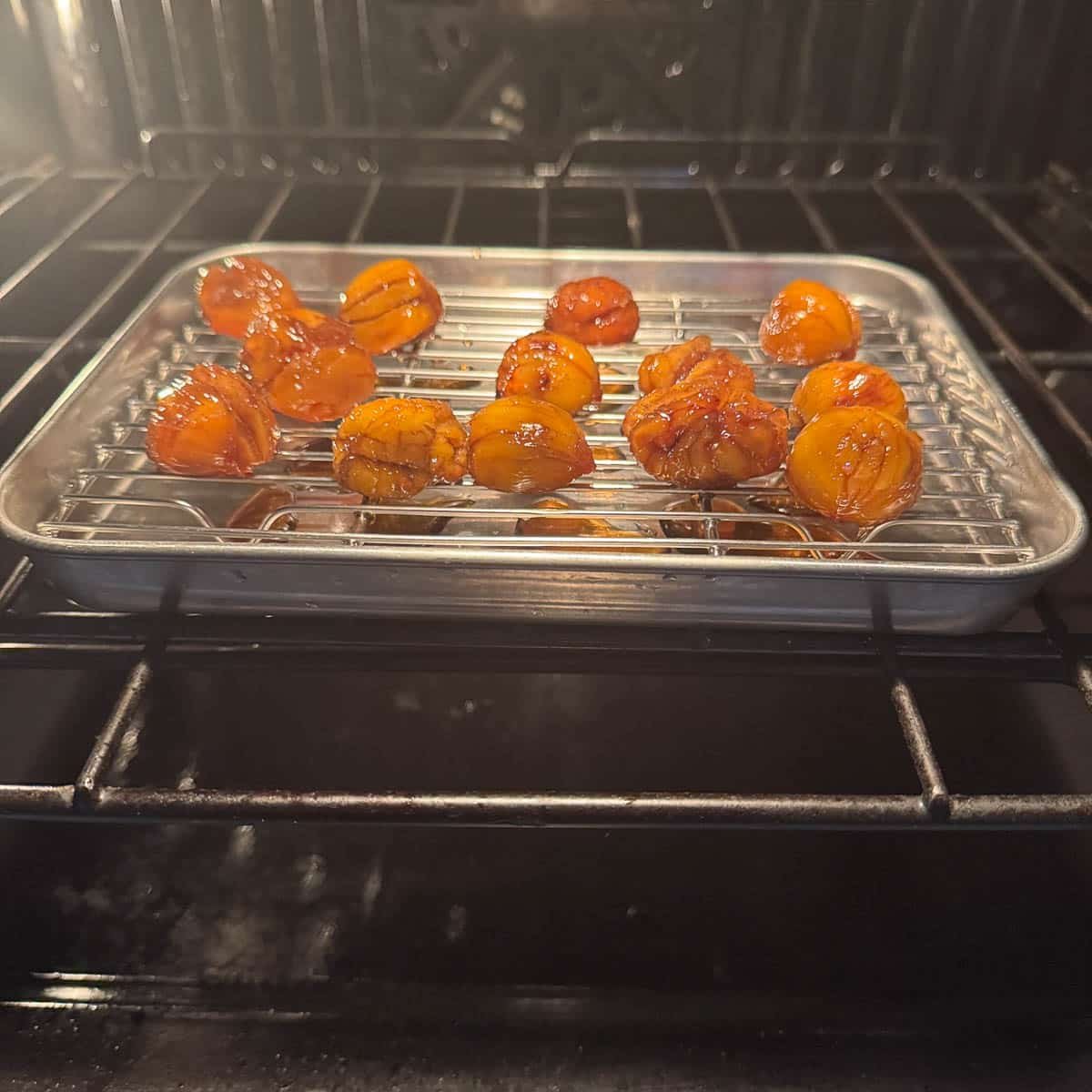 marron glace on a rack in the oven.