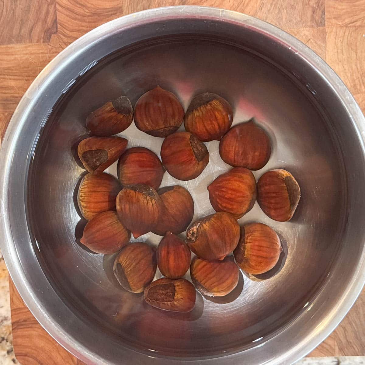 chestnuts soaking in a bowl of water