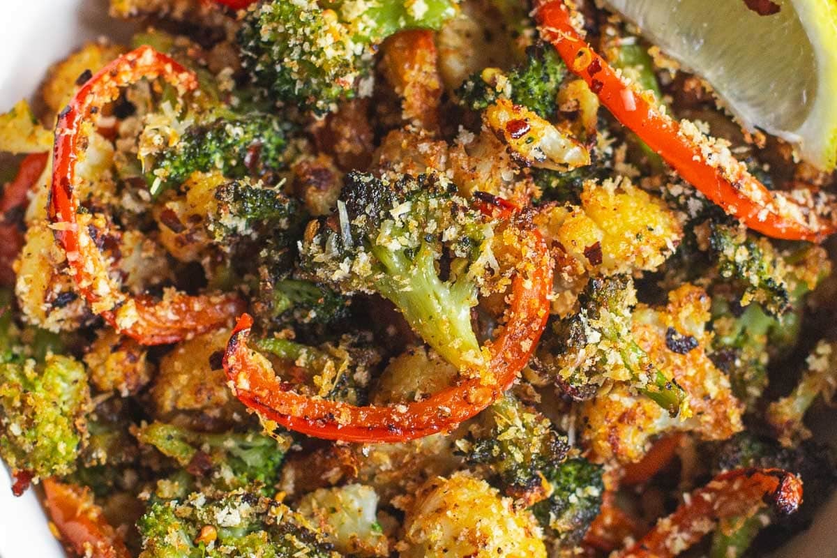 roasted broccoli, cauliflower and red peppers in bowl.