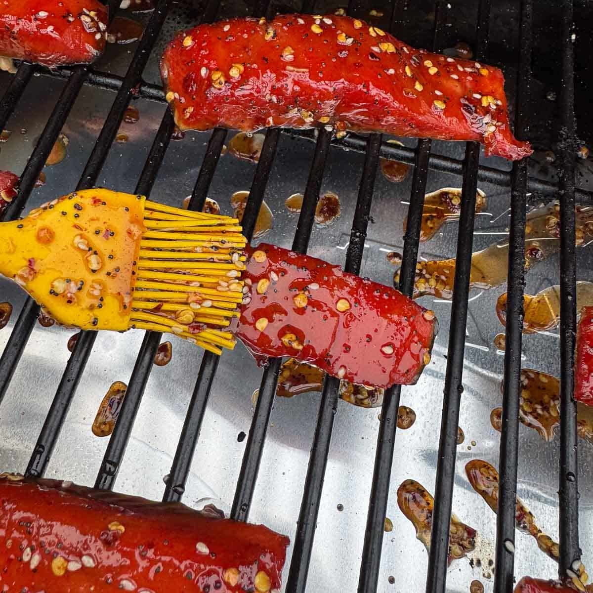 salmon strips being glazed