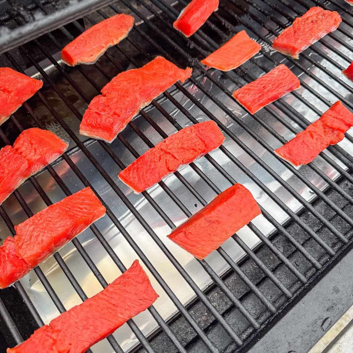 salmon strips being smoked
