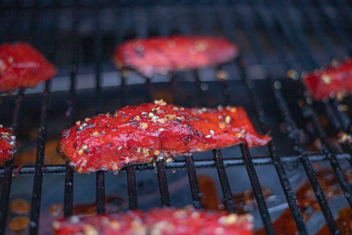salmon candy strips being smoked