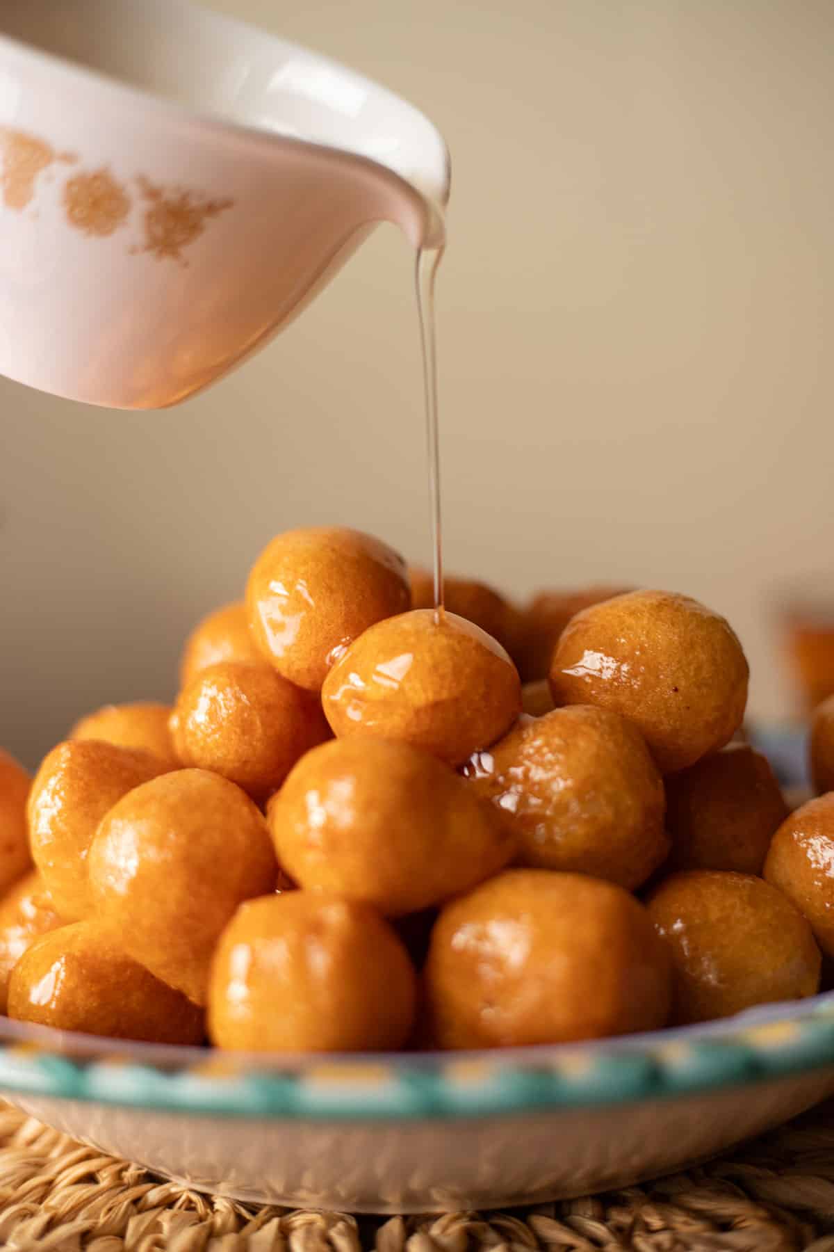 syrup being poured over lokma