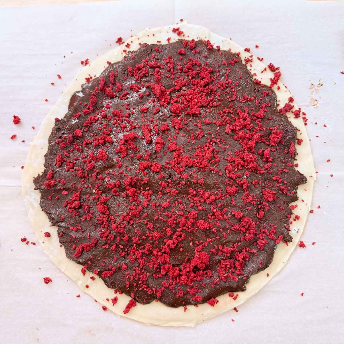 crushed raspberries sprinkled over chocolate spread.