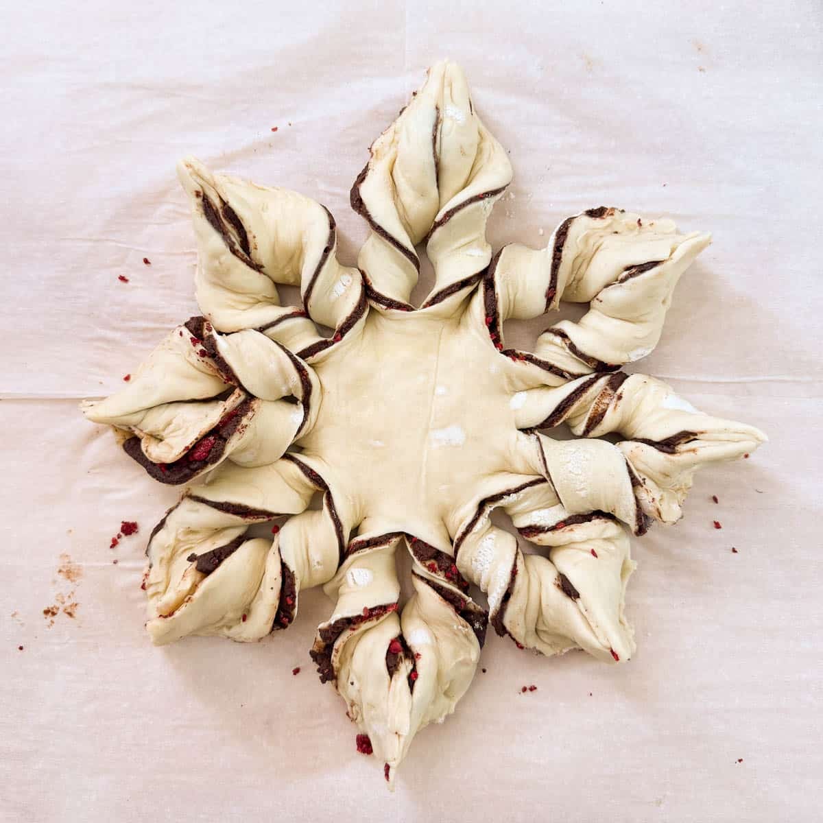 chocolate puff pastry snowflake after twisting all the strips.