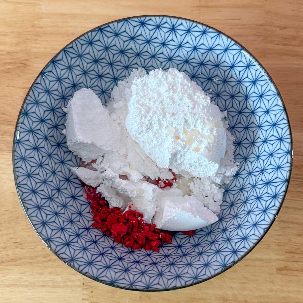 raspberry powder and powdered sugar in bowl before mixing.