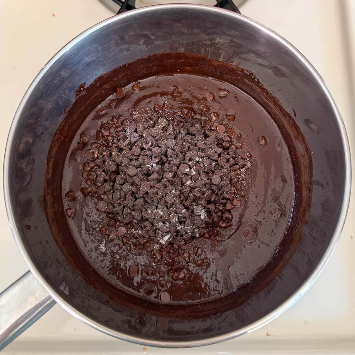 chocolate morsels melting atop chocolate sauce.