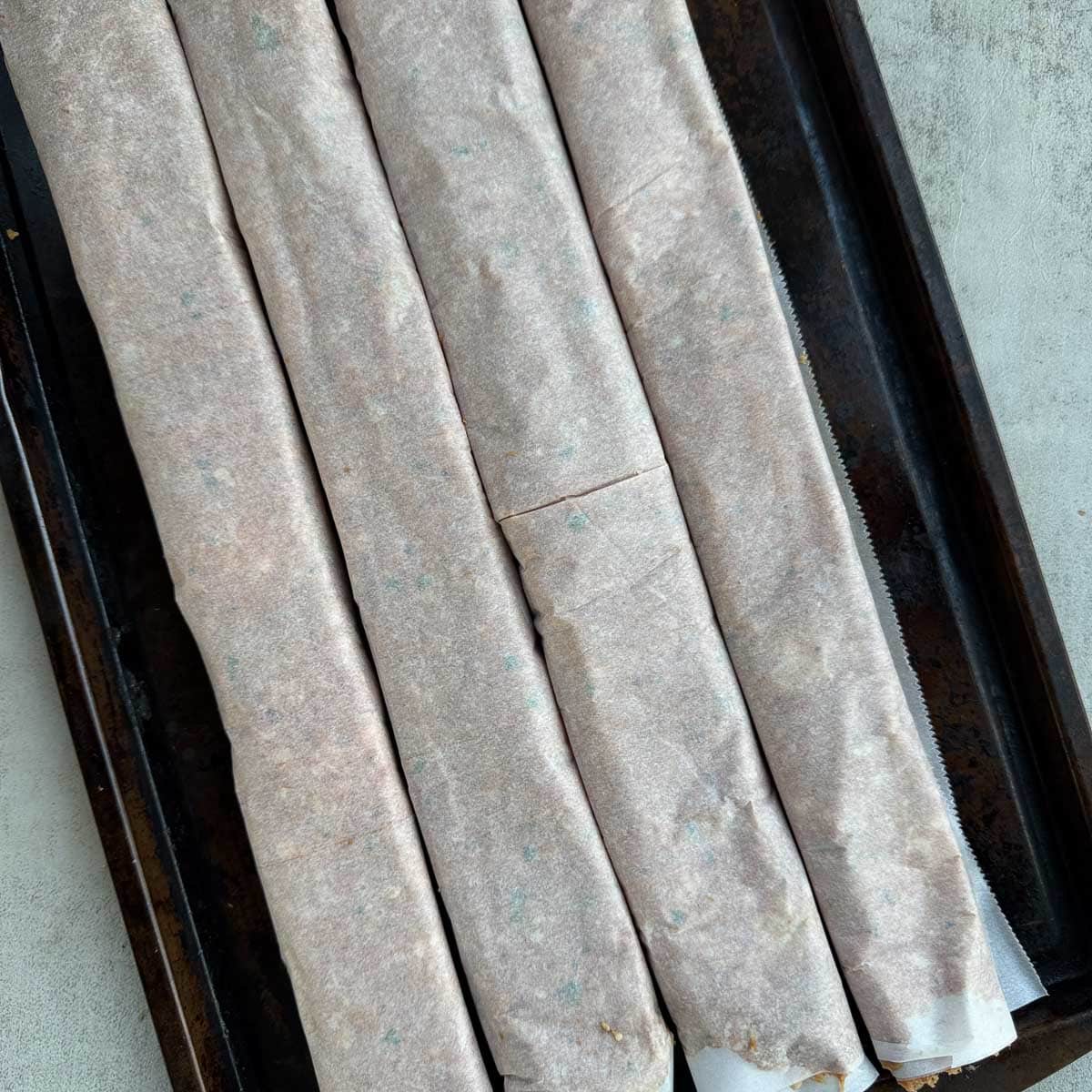 rolls of doner kebab meat on a tray