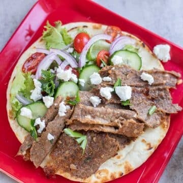 doner kebab on a red plate with veggies