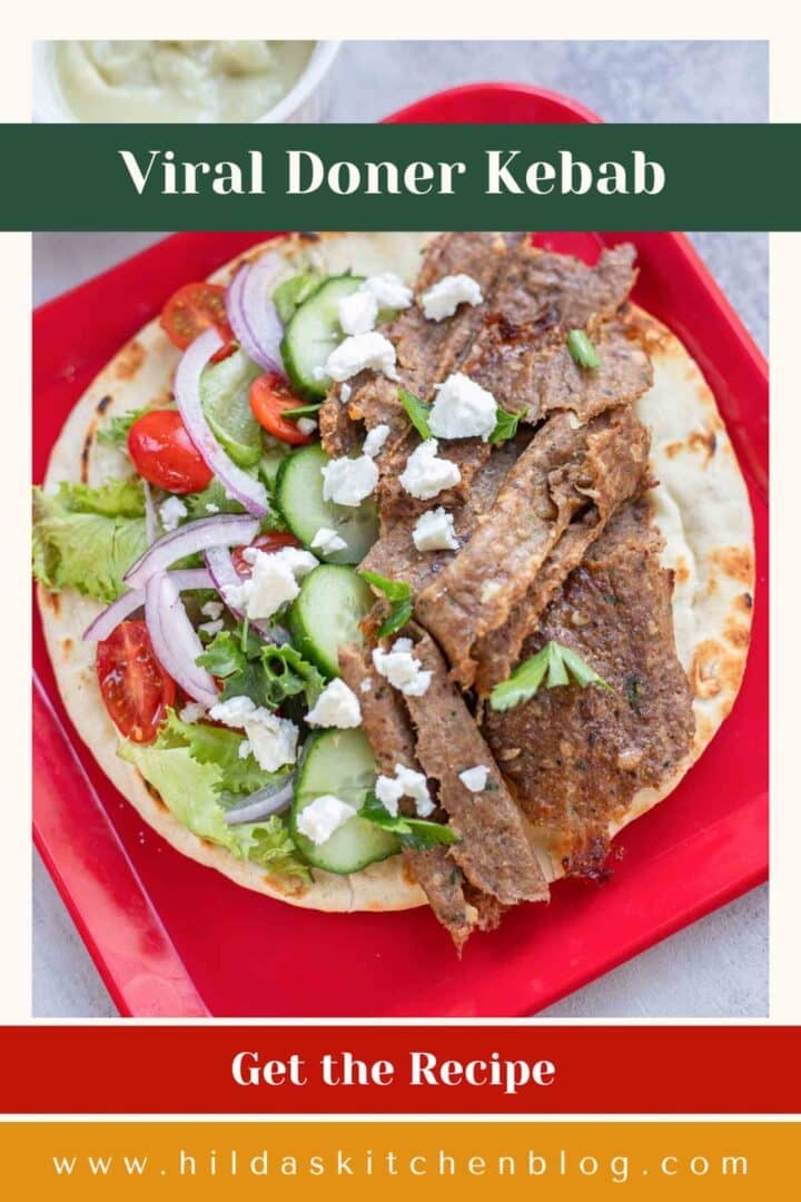 doner kebab on a red plate with veggies and crumbled feta
