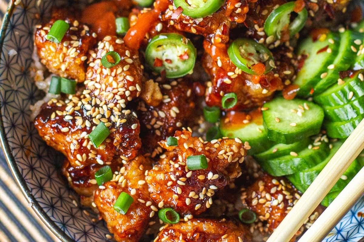 sticky sesame chicken topped with green onions and serranos.