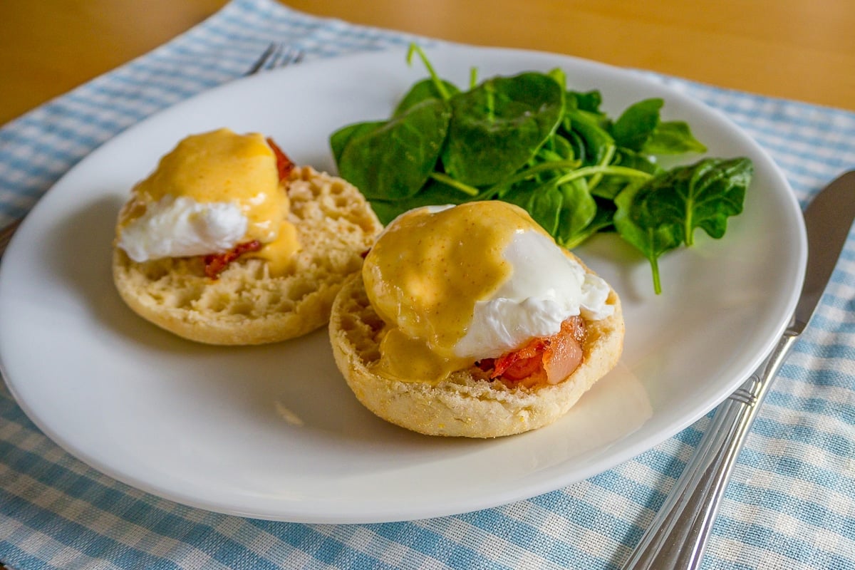 hollandaise sauce drizzled over eggs benedict.