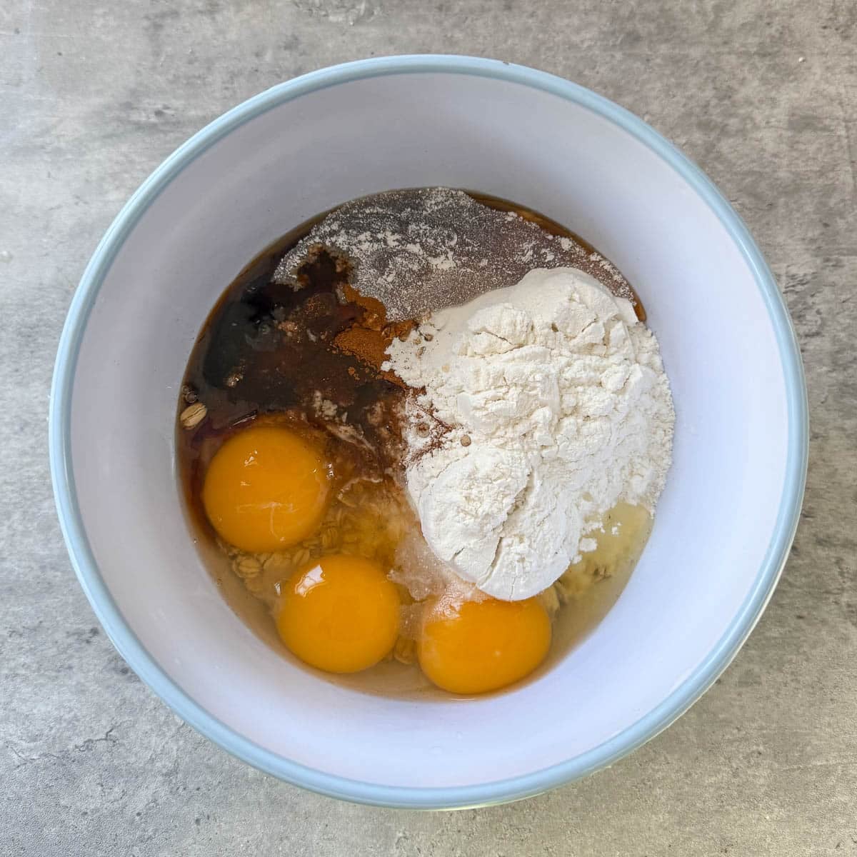 batter ingredients such as oats, eggs, protein powder, etc. in bowl before mixing.