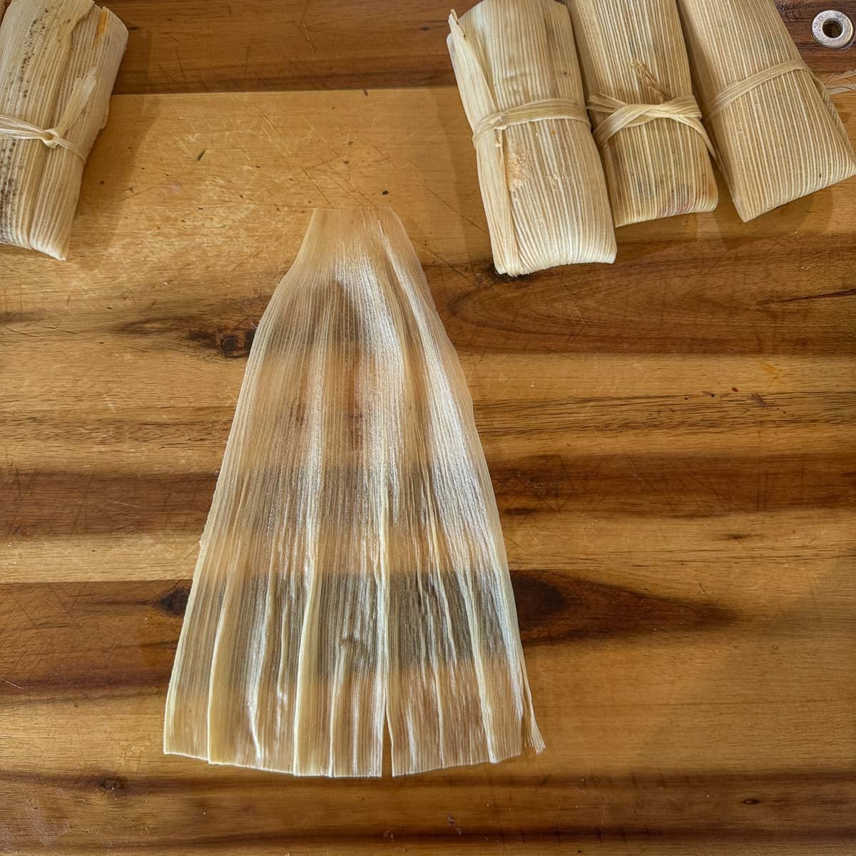 corn husks on a cutting board