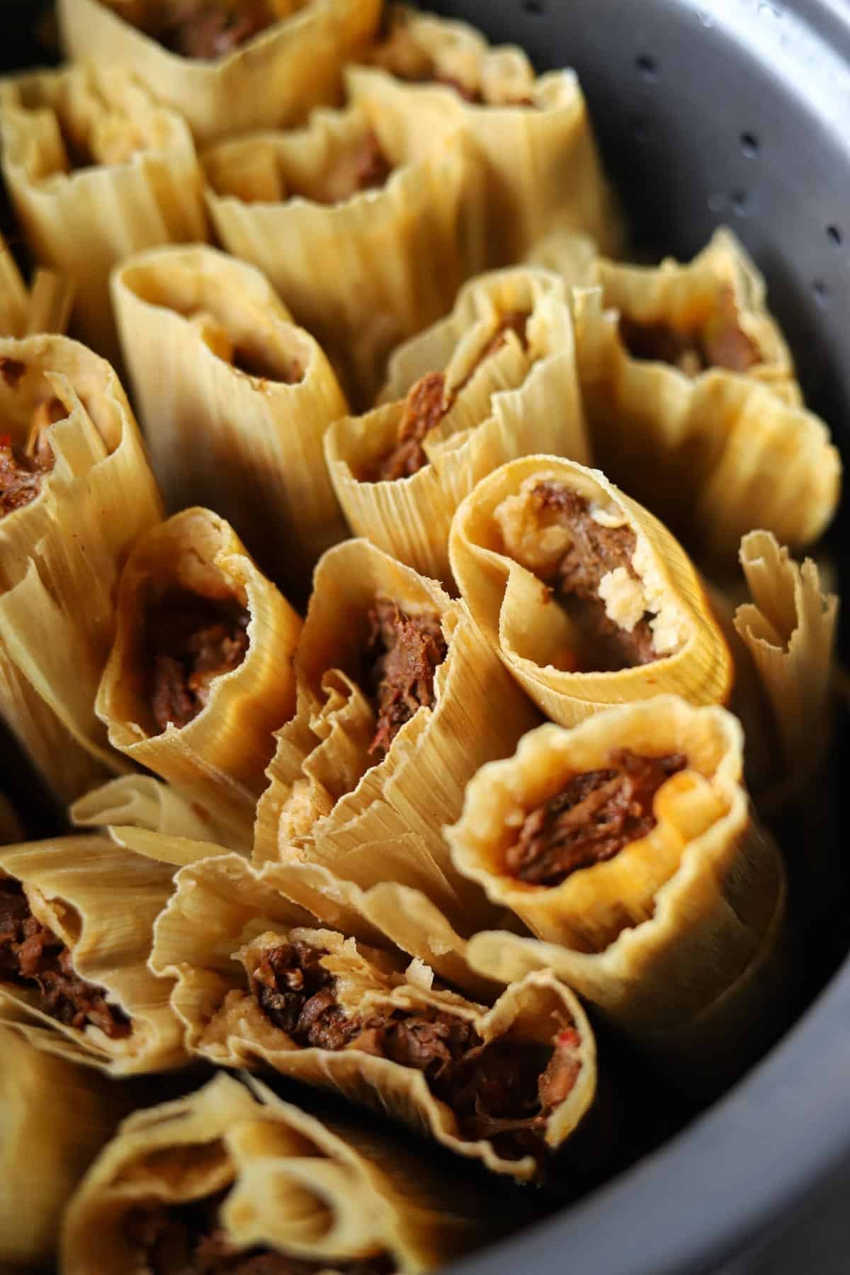 beef tamales in a steamer basket