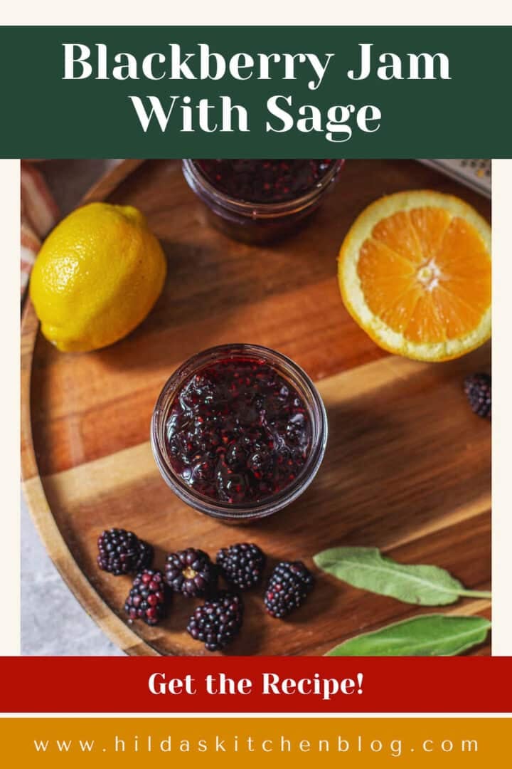 jar of no pectin blackberry jam beside fresh fruit and sage.