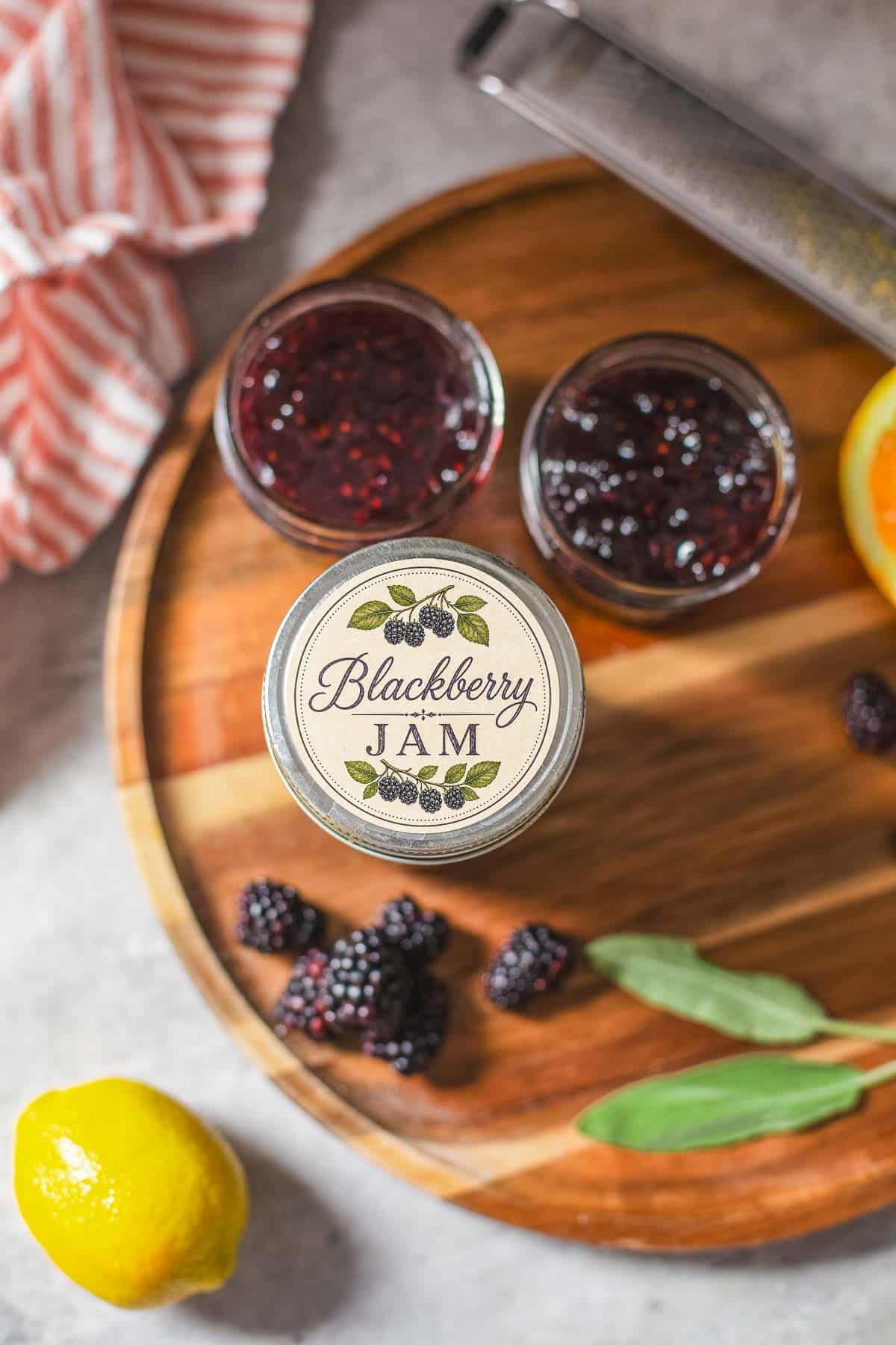 no pectin blackberry jam in jars with label beside fresh fruit.