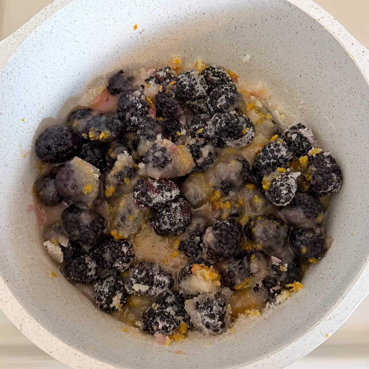 blackberries and sugar in pot.
