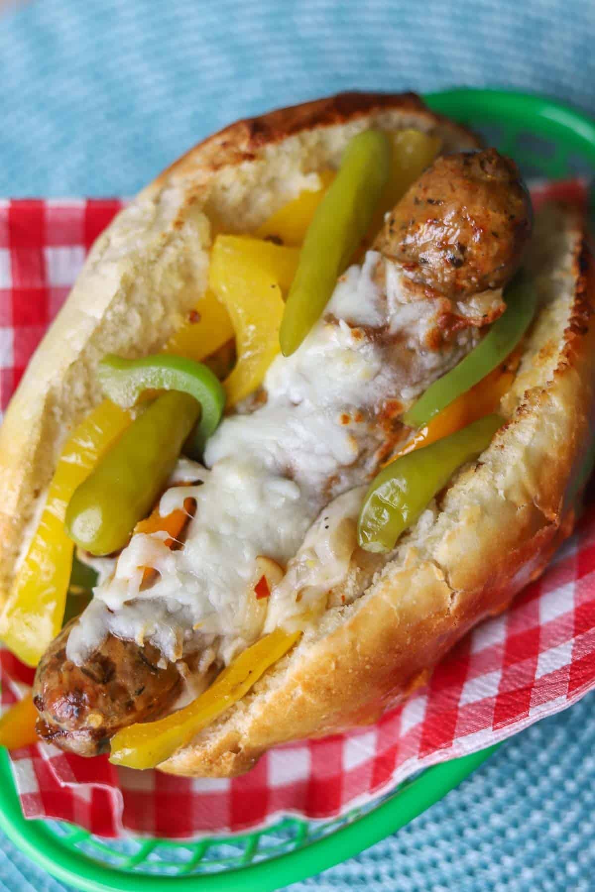 Italian sausage sandwich with peppers, onions, and cheese