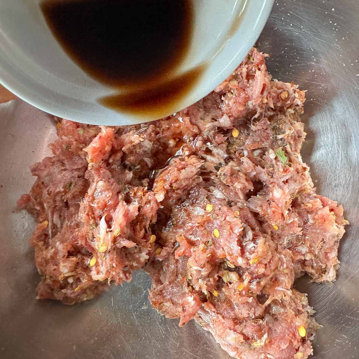 adding vinegar to pork mixture