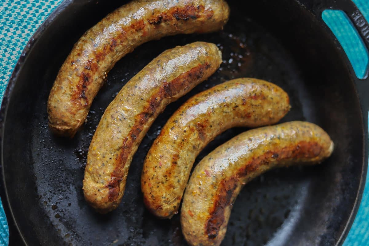 Italian sausage links in a cast-iron pan