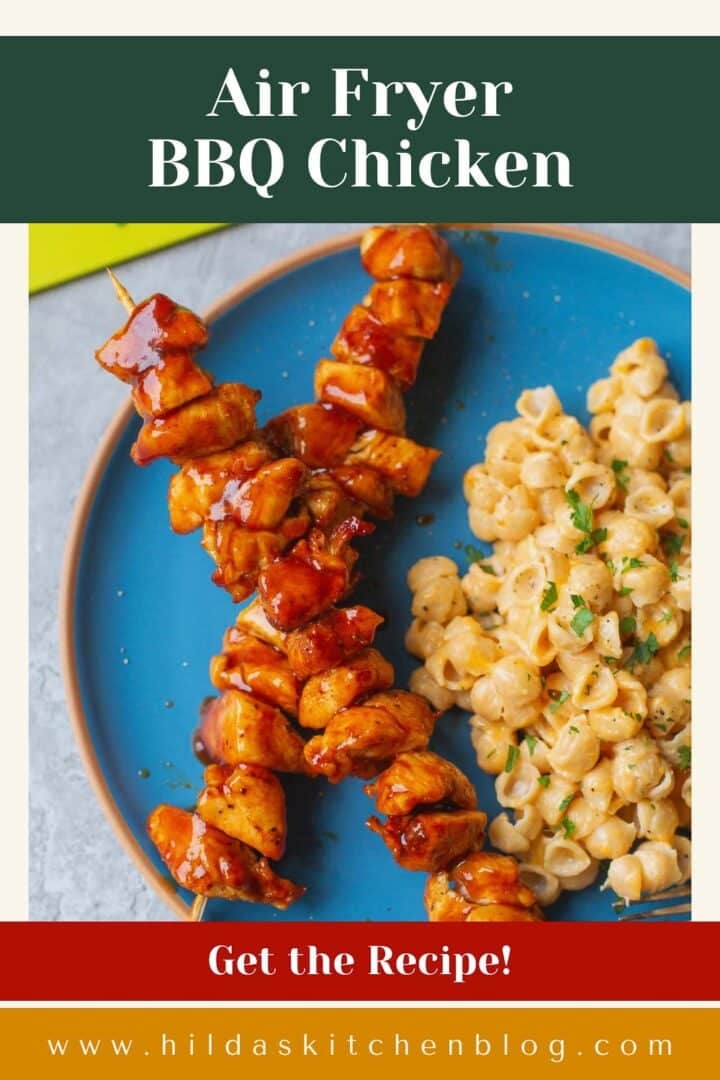 air fried bbq chicken on skewers beside mac and cheese.