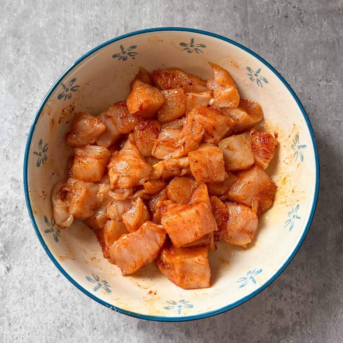 seasoned cubed raw chicken.
