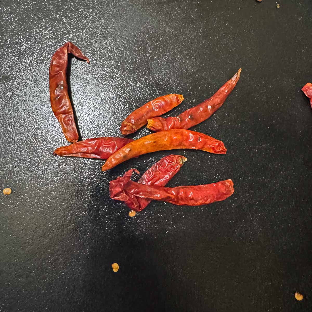 arbol chiles in a cast iron skillet