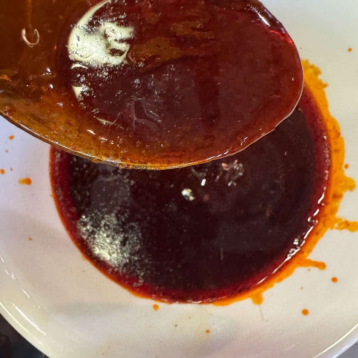 adding skimmed fat to a white bowl