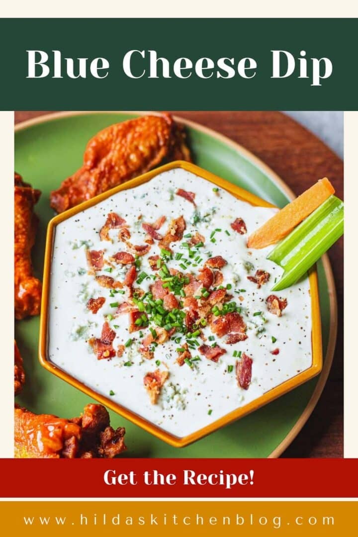 blue cheese dip for hot wings with buffalo wings and veggie sticks.