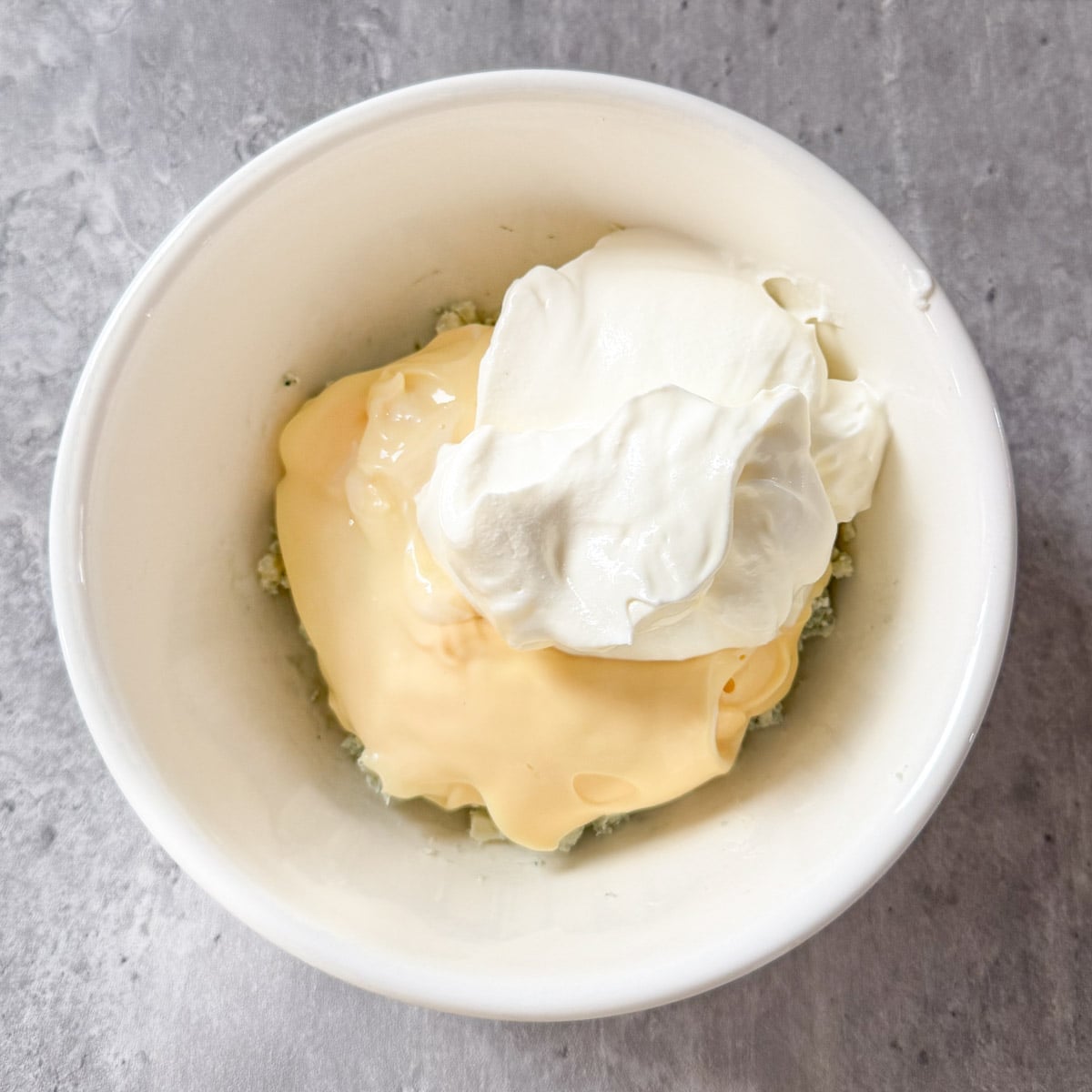 sour cream and mayonnaise added to the blue cheese crumbles.