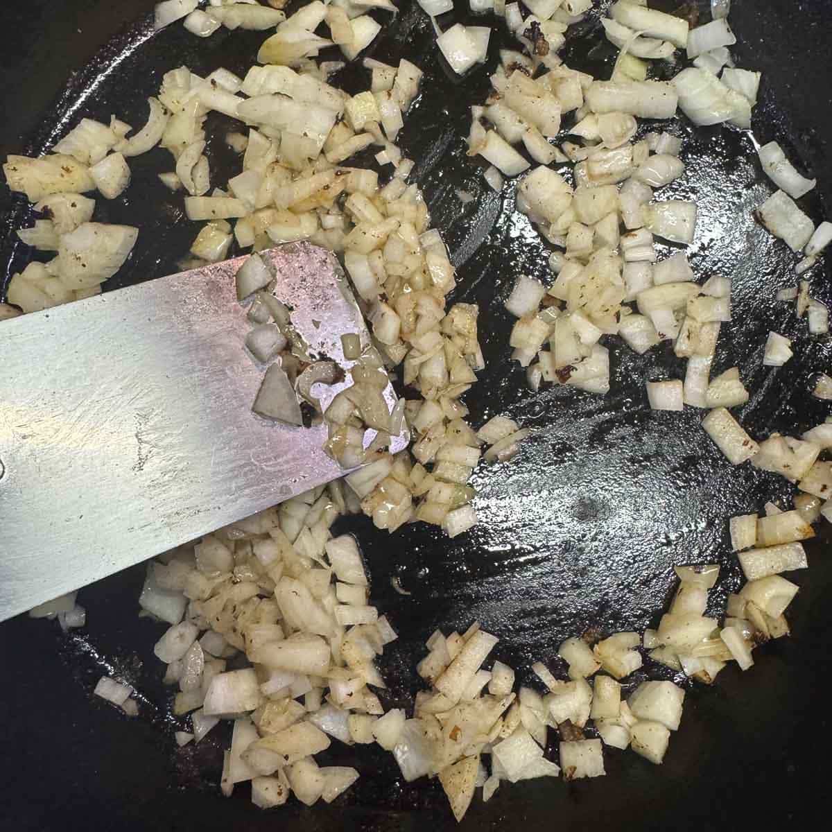diced onions being sauted