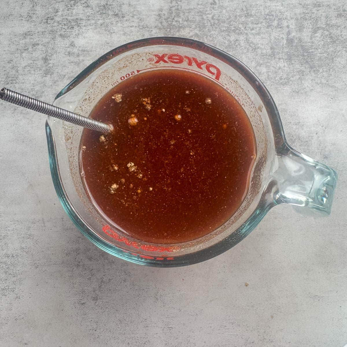 cooking liquid for country style ribs in a measuring cup