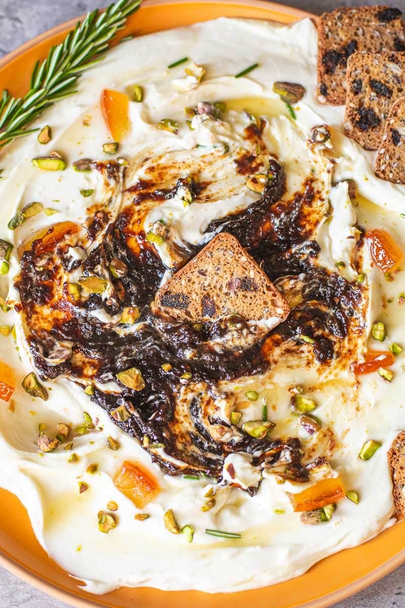 cracker dipped in whipped goat cheese dip.