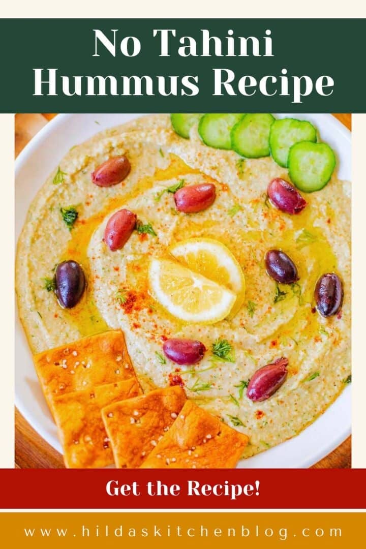 homemade hummus without tahini recipe topped with kalamata olives, lemon, cucumbers, pita chips.
