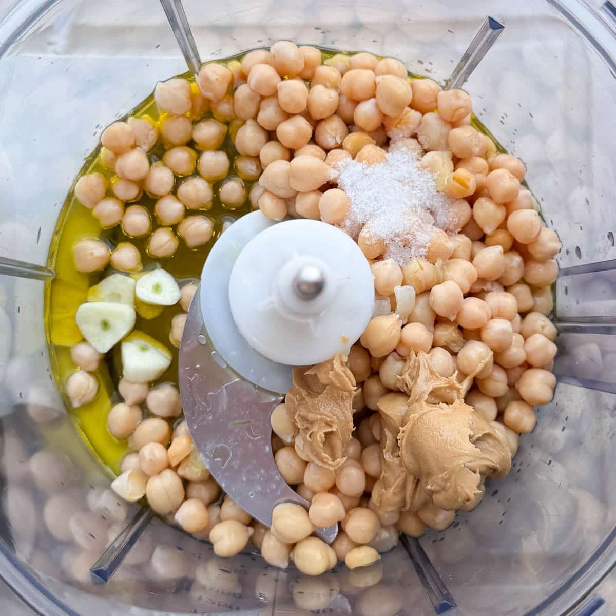 hummus without tahini base ingredients in food processor (chickpeas, lemon, oil, peanut butter, garlic, salt.)