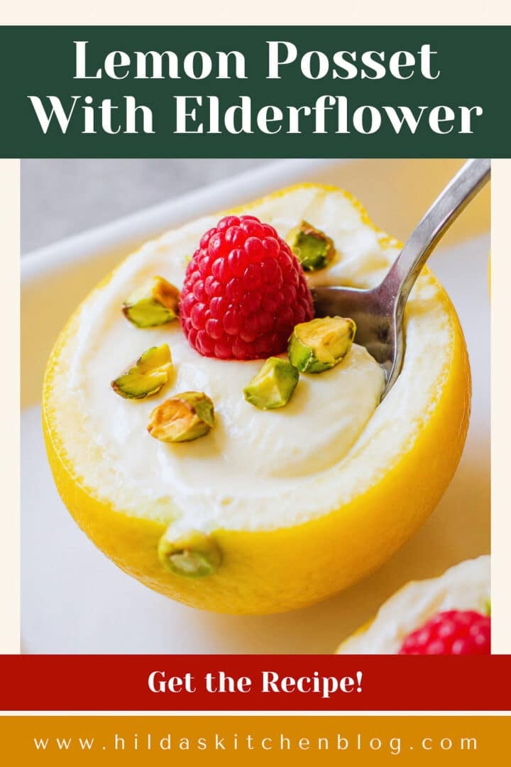 lemon posset in lemon skins with raspberries and pistachios and a spoon.