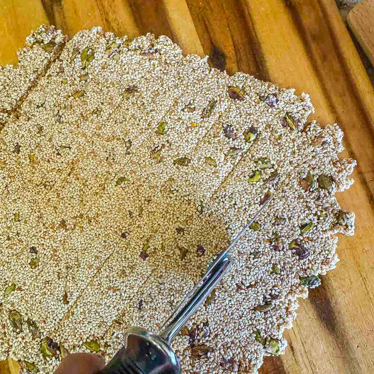 pasteli being scored with a pizza cutter 