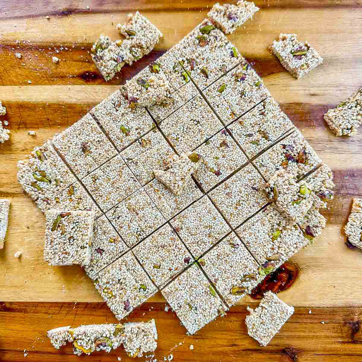 sesame seed candy cut into squares on a cutting board