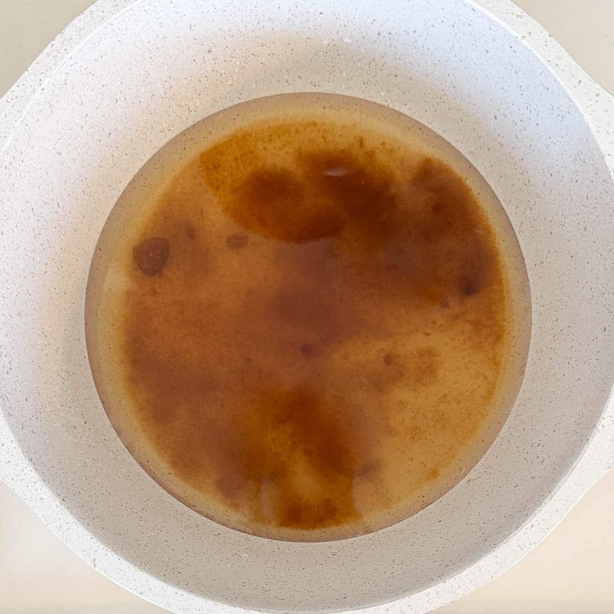 Sugar dissolving in water.