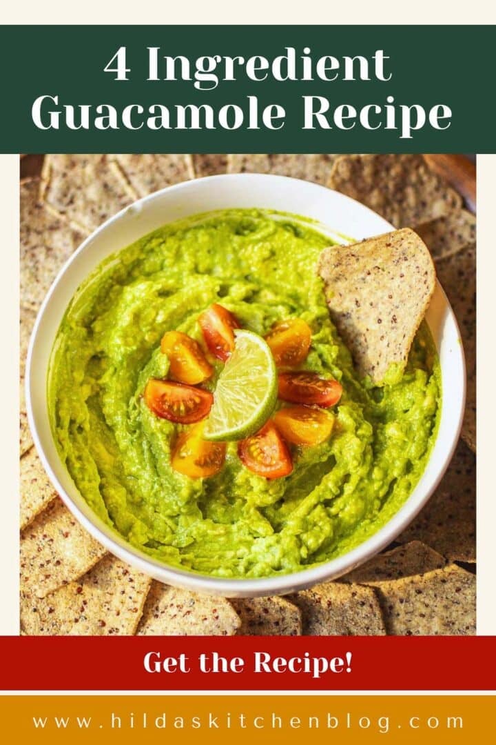 4 ingredient guacamole garnished with cherry tomatoes and lime surrounded by tortilla chips.
