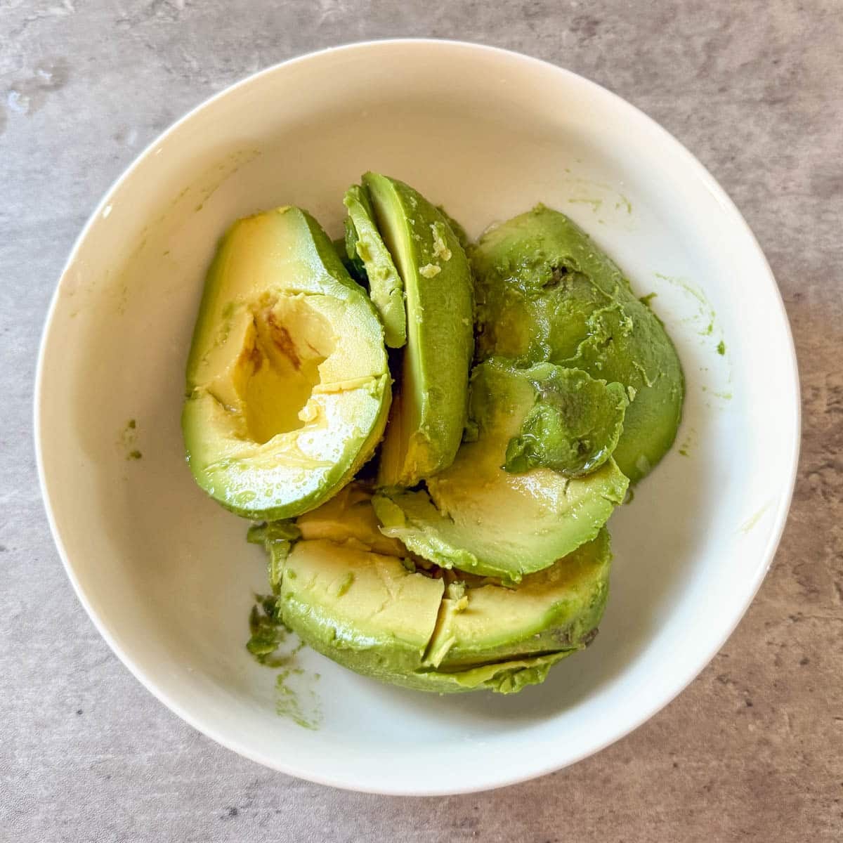 avocados in bowl before mashing.