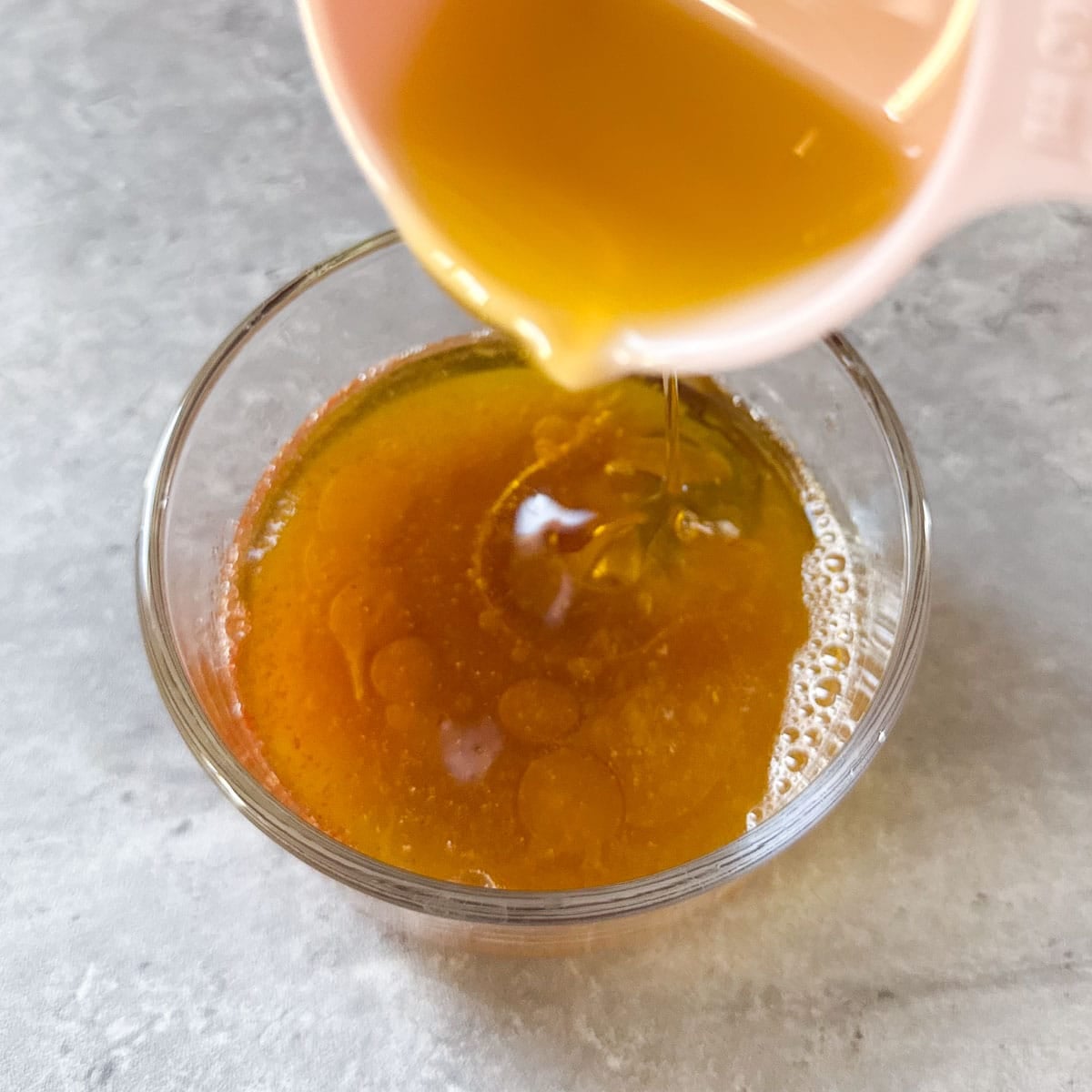 oil being poured into vinaigrette.