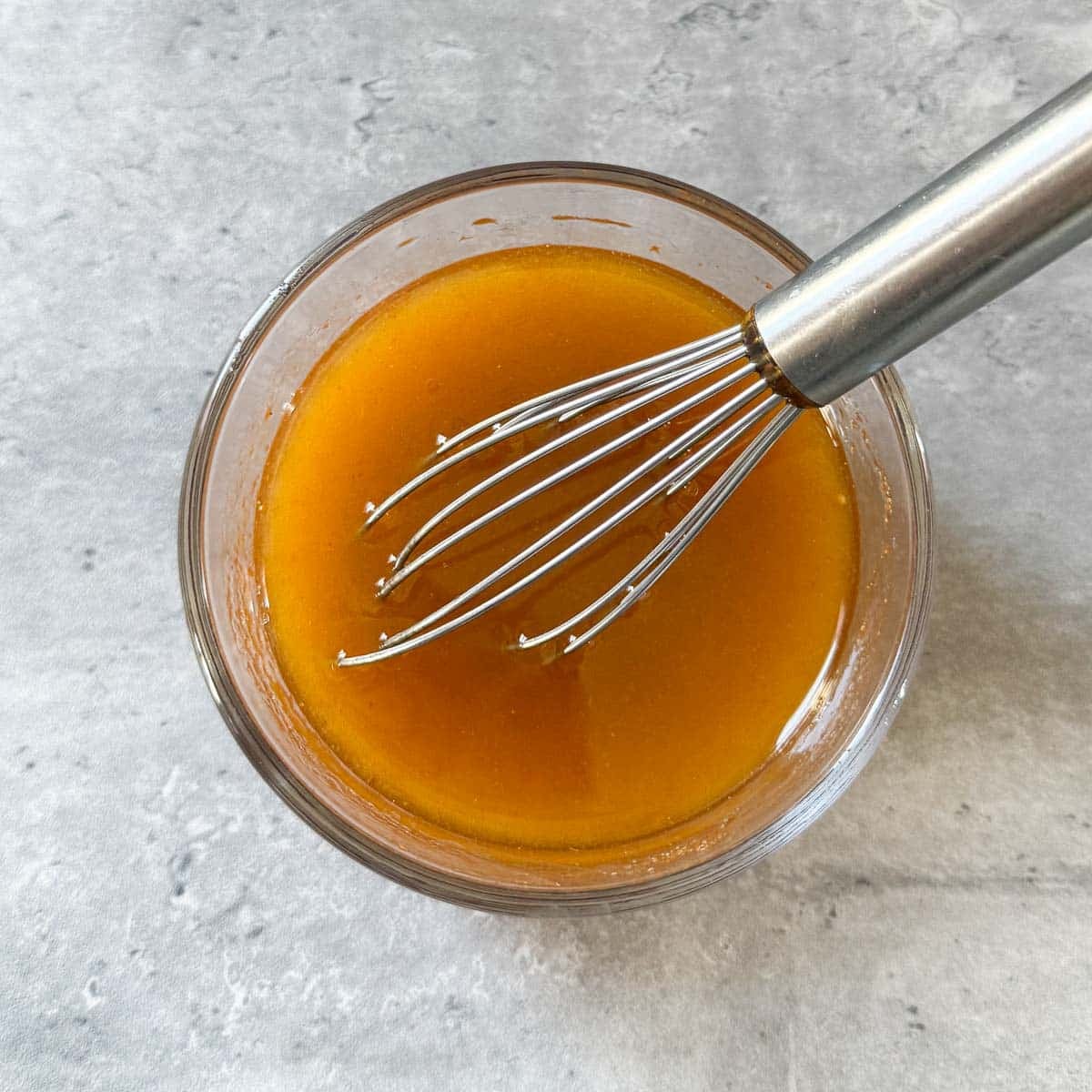 vinaigrette with whisk in it.