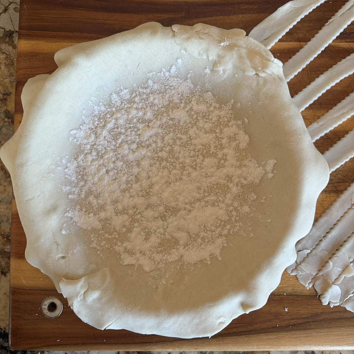 pie crust in a pie plate with flour sprinkled on it